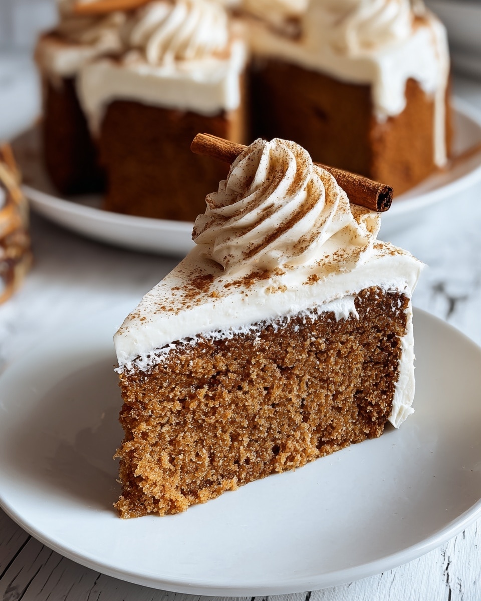 A close-up of a square slice of gingerbread cake with two visible layers: the bottom layer is a dense, dark brown gingerbread cake with a slightly crumbly texture, and the top layer is a thick white whipped cream frosting spread evenly over the cake. On top of the frosting, there is a swirl of whipped cream dusted with a light brown spice powder, likely cinnamon or nutmeg. The cake slice sits on a white plate with a simple design, placed on a white marbled surface. The background is softly blurred with warm tones. photo taken with an iphone --ar 4:5 --v 7