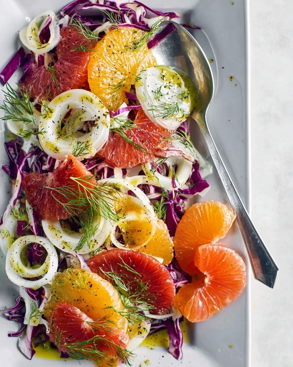 A fresh salad is shown on a white rectangular plate placed on a white marbled texture. The salad has three main layers: the bottom layer of purple cabbage shreds, the middle layer of bright orange and red citrus slices including oranges and grapefruit, and the top layer of white fennel slices with thin leaves of green dill scattered all over. There is a light drizzle of greenish-yellow dressing along with coarse black pepper sprinkled on top. A silver spoon is placed in the middle right side of the plate holding some grapefruit segments. Photo taken with an iphone --ar 4:5 --v 7
